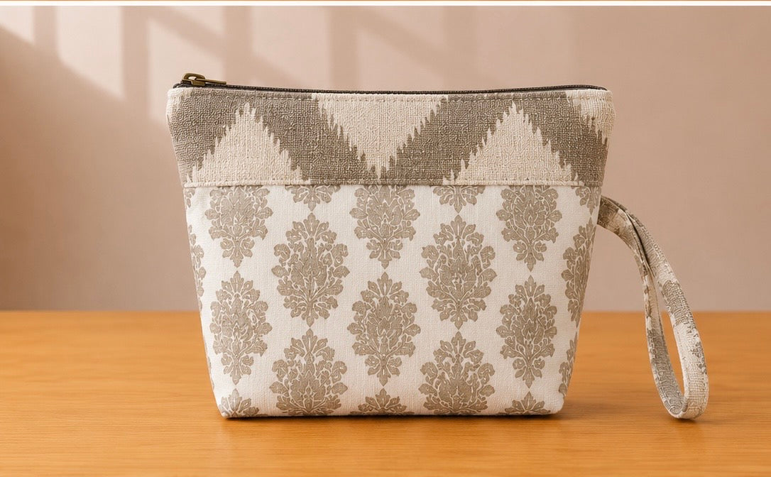 Back view of NO.011 Studio Pouch – Stone Arcade with neutral stone patterned fabric, zipper closure, and matching wrist strap.