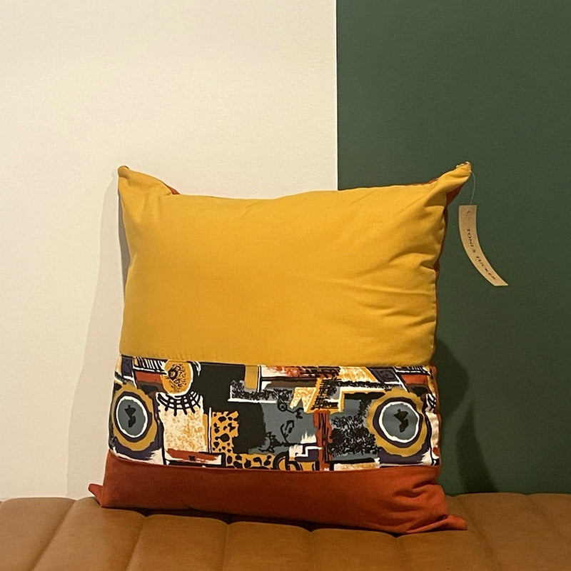 NO.001 Studio Pillow – Golden Rust Block front view featuring reclaimed mustard, rust, and geometric patterned textile panels.