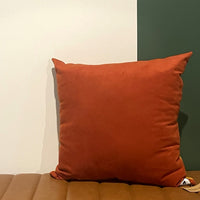 NO.001 Studio Pillow – Golden Rust Block reverse view showing coordinating neutral fabric and Toni & Tucker label.
