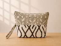 Back view of NO.002 Studio Pouch – Olive Grove with neutral patterned panels and matching wrist strap.