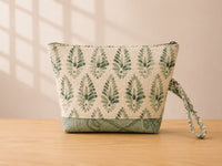 Back view of NO.003 Studio Pouch – Sage Lattice with tonal sage patterned fabric, zipper closure, and matching wrist strap.