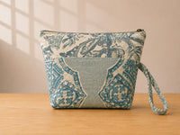 Back view of NO.004 Studio Pouch – Garden Pavilion with green and blue ornamental textile panels and matching wrist strap.