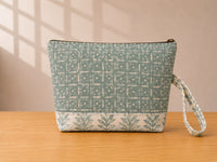 Back view of NO.006 Studio Pouch – Mist Fern with soft blue gray patterned textile and matching wrist strap.