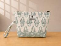 Front view of NO.006 Studio Pouch – Mist Fern with soft blue gray textile, label, zipper closure, and wrist strap.