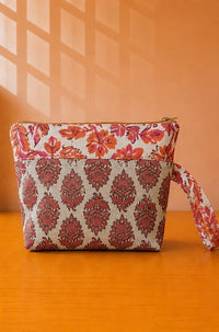 Back view of NO.010 Studio Pouch Terracotta Fern with red floral and fern patterned fabric and wrist strap.