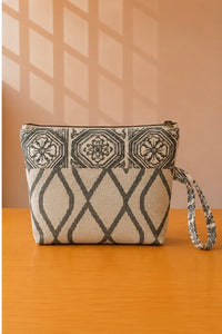 Back view of NO.012 Studio Pouch Botanical Conservatory with neutral tile and trellis patterned fabric and wrist strap.