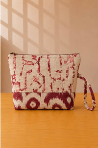 Back view of NO.013 Studio Pouch – Crimson Bazaar with cream and red patterned textile, zipper closure, and matching wrist strap.