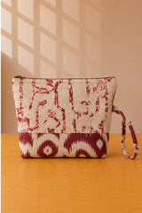 Back view of NO.013 Studio Pouch – Crimson Bazaar with cream and red patterned textile, zipper closure, and matching wrist strap.